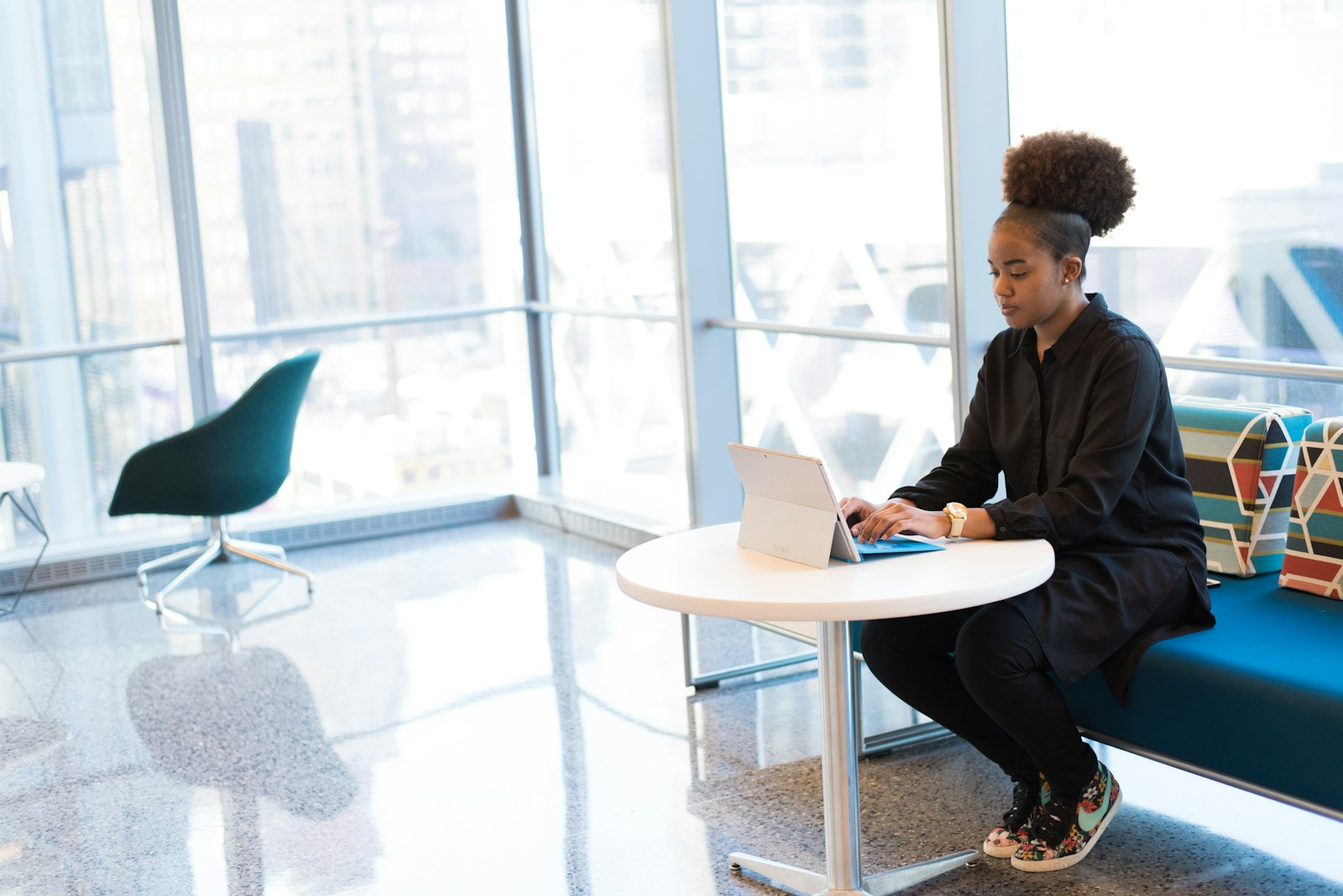 An engineer working at a tablet in a bright modern office